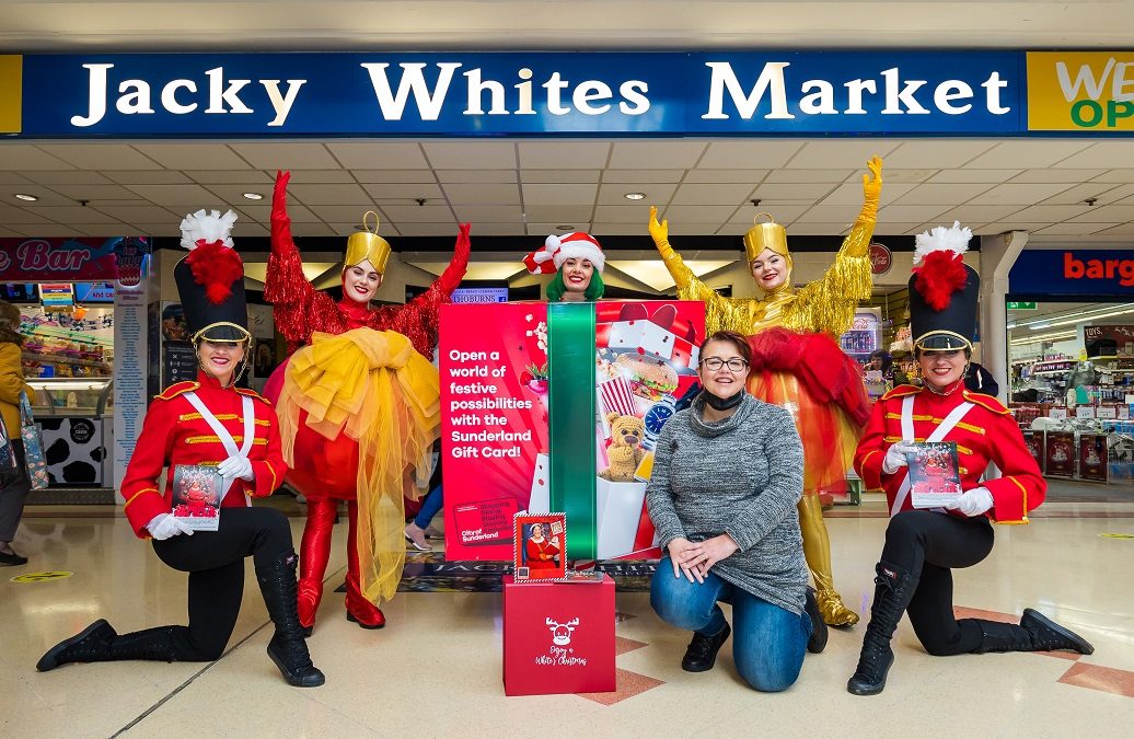 Cllr Claire Rowntree with Christmas characters outside Jacky Whites Market